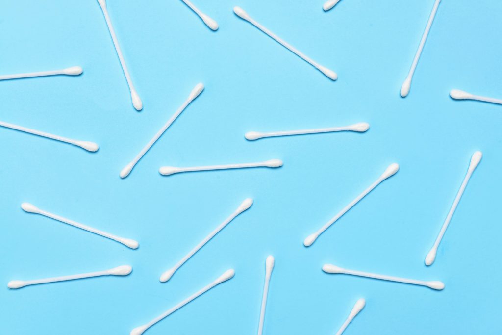 Q-tips laying on a flat surface.